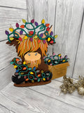 MDF highland cow with box of fairy lights