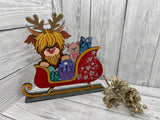 MDF highland cow in sleigh